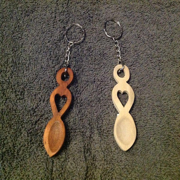 Small carved wooden love spoon attached to keyring